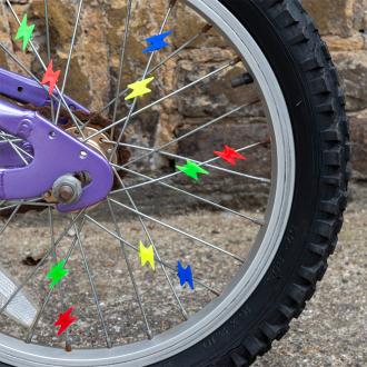 bicycle wheel with colourful lightning bolt-shaped spoke decorations