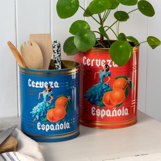Two large Cerveza Española tins used as utensil holder and plant pot.
