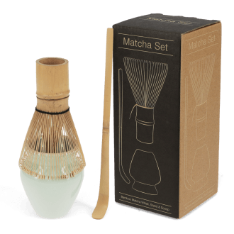 Matcha set with bamboo whisk, ceramic whisk holder, and scoop, displayed beside a labelled box 