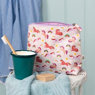 Wash bag in pale pink featuring colourful illustrations of unicorns, rainbows and stars with tag