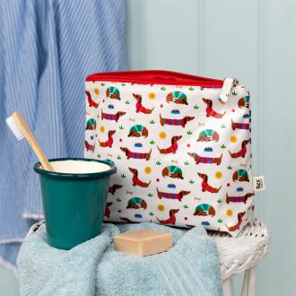 wash bag in white featuring colourful illustrations of sausage dog 