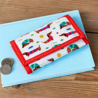 Wallet in white featuring colourful illustrations of sausage dog wearing striped jumper