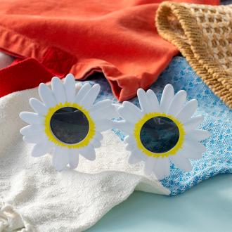 funglasses with a white daisy-shaped frame and dark lenses.