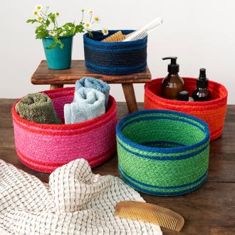 Four woven storage baskets in varying sizes and colours