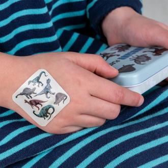 Plaster applied to a kids' hand with a dinosaur-themed design.