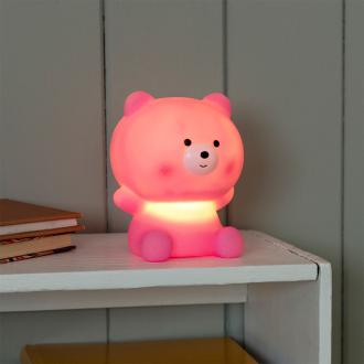 Pink teddy bear night light with light on