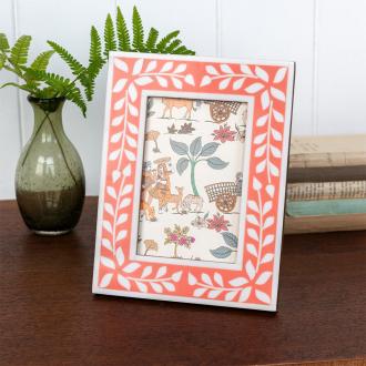 picture frame with a pink border and white leaf patterns