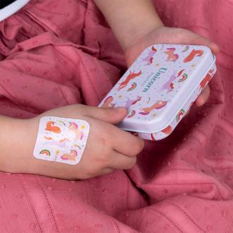 Plaster applied to a kid's hand with a unicorn-themed design.