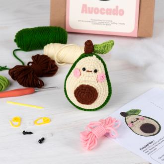 Avocado crochet kit with packaging and finished crocheted avocado beside it