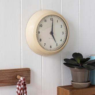 Round cream wall clock with black hands and numbers