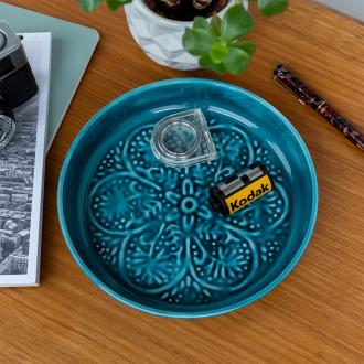 Enamel trinket dish in blue displayed with a camera film roll 