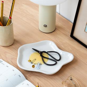 White ceramic trinket dish shaped like a fried egg with yellow yolk design