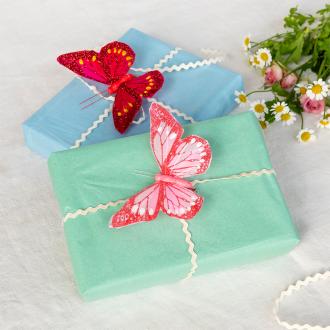 Two bright pink butterfly clip‑on decorations.