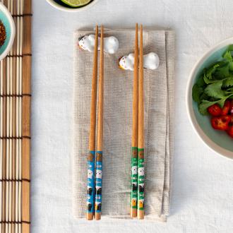 Cat-themed chopsticks set with two ceramic rests.