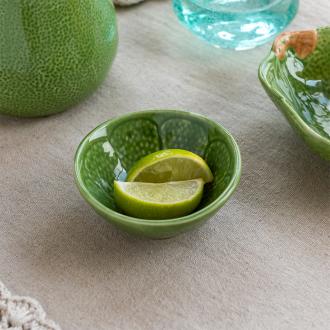 Green ceramic bowl with textured lime-like pattern and glossy finish.