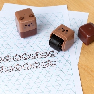 Brown bear-themed roller stamp with the cap removed,