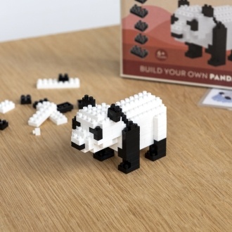 Completed panda brick model displayed beside its packaging box.