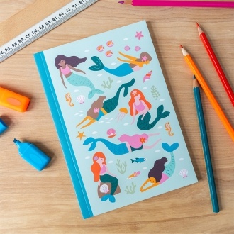 Notebook with illustrated mermaids, sea creatures, and shells on a light aqua cover.