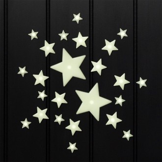 Glow‑in‑the‑dark star shapes in different sizes on a black background.