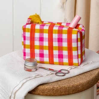 Pink and yellow gingham quilted makeup bag with a zip and tassel.