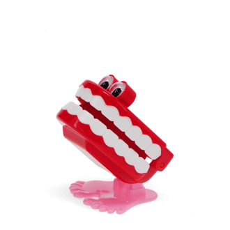 Wind-up toy shaped like red chattering teeth with white teeth, googly eyes, and pink feet