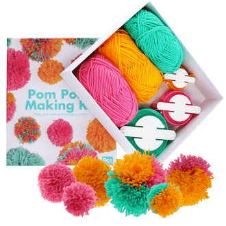 Pom‑pom making kit with colorful yarn, pom‑pom tools, and finished pom‑poms.
