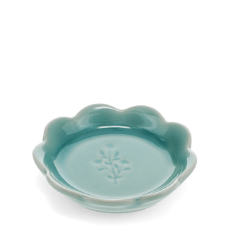 Ceramic trinket dish with a scalloped edge and a floral design in the centre.