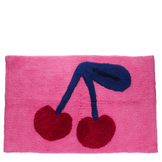 Pink bath mat with a cherry design in red and dark blue.