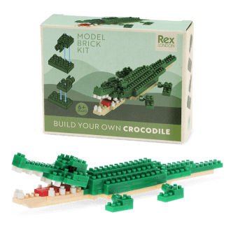 Completed crocodile brick model displayed beside its packaging box.