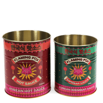 Two Flaming Fox Korean sauce storage tins, one red hot sauce and one green bibimbap design