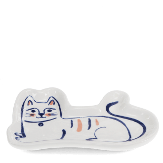 White ceramic trinket dish shaped like a reclining cat with simple blue and orange details.
