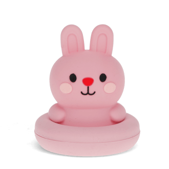 Pink silicone bunny bath toy with upright ears and simple face, in round base