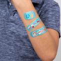 Light blue plasters with retro style top banana print on child's arm