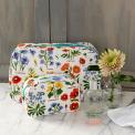 White oilcloth wash bag and makeup bag collection with wild floral pattern