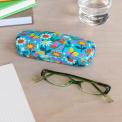 Light blue hardshell glasses case with print of butterflies amongst flowers on table