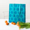 Recycled plastic shopping bag blue circles turquoise background