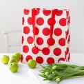 Recycled plastic shopping bag red circles cream background