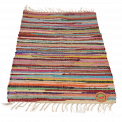 Multicoloured handloomed cotton rug laid flat with swing tag showing