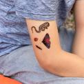 Child wearing Nature Trail temporary tattoos on arm