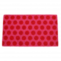 Coir doormat with red spots on pink surface