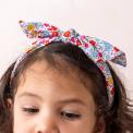 A child wearing a colourful floral fabric headband - Tilde