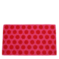Coir doormat with red spots on pink surface