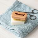 wooden nail brush featuring a sausage dog illustration
