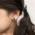 girl wearing small black cat-shaped earring