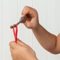 Red slingshot with a sticky, poop-shaped held by a child