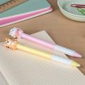 Pink and yellow retractable ballpoint pen with cat and tiger sitting atop