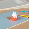 Rabbit-shaped pencil sharpener with coloured pencils placed beside