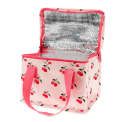 Insulated lunch bag decorated with cherry pattern on a light pink background and a zip opening