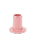 Pink ceramic candle holder with a cylindrical shape and wide flat base