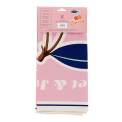 Cotton tea towel featuring a cherry print with pink background in a packaging